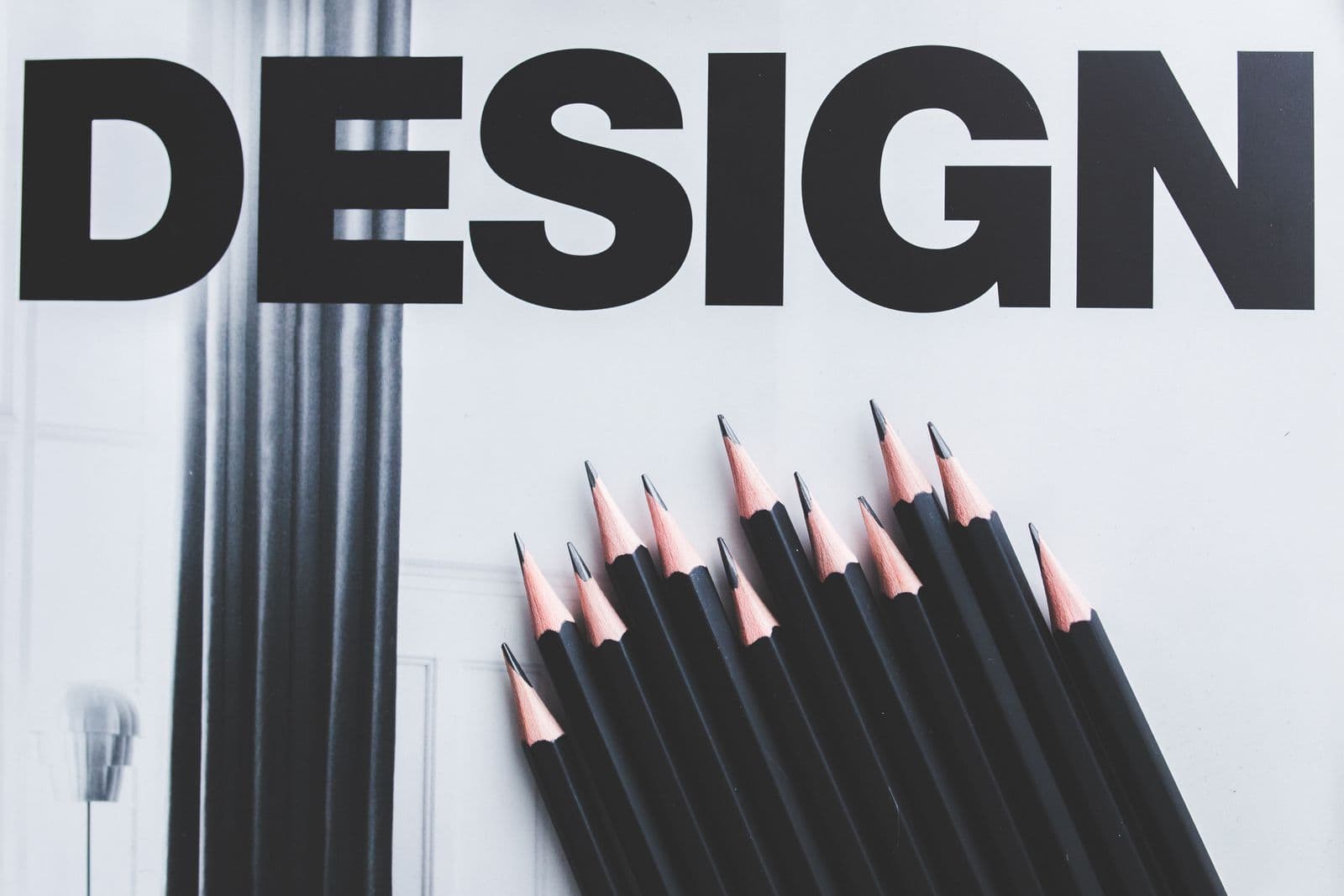 A printed design poster with drawing pencils